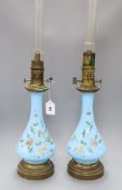 A pair of French enamelled bleu celeste glass oil lamps