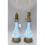 A pair of French enamelled bleu celeste glass oil lamps