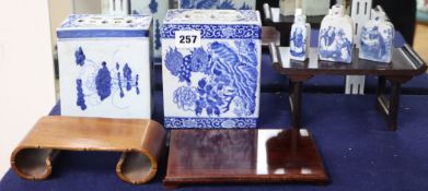 Two Chinese blue and white pillows and three similar snuff bottles, with three hardwood stands