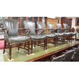 A set of twelve George III style mahogany elbow chairs, upholsterd in studded green leather