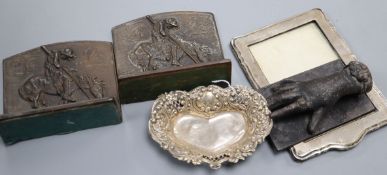 A pair of bronze bookends, a cup and a silver frame and silver dish