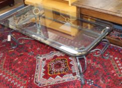 A wrought iron framed coffee table, with plate glass top W.120cm