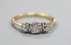 An 18ct and three stone diamond ring, the central stone weighing approximately 0.50cts, size Q.