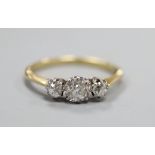 An 18ct and three stone diamond ring, the central stone weighing approximately 0.50cts, size Q.