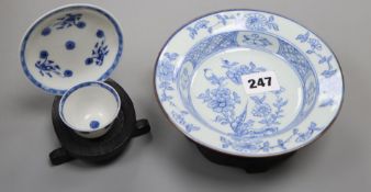 An 18th century Chinese blue and white tea bowl and saucer, and a similar bowl and two hardwood