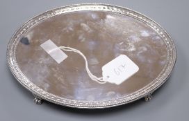 A George III silver oval stand or salver, on claw and ball feet, by Crouch and Hannam, London, 1778,