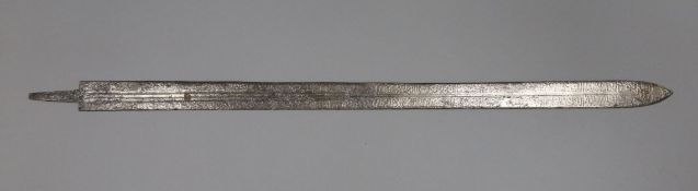 A fullered steel sword, decorated throughout with a Middle Eastern inscription length 37.5in.