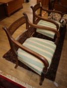 A pair of Regency mahogany elbow chairs