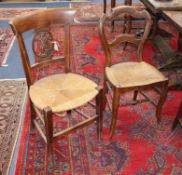 A set of five French beech rush seat dining chairs, with carved figural splats together with two