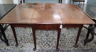 A George III mahogany pad foot drop leaf dining table on eight tapered legs 180cm extended