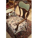 A late Victorian mahogany elbow chair, with rose branch upholstery