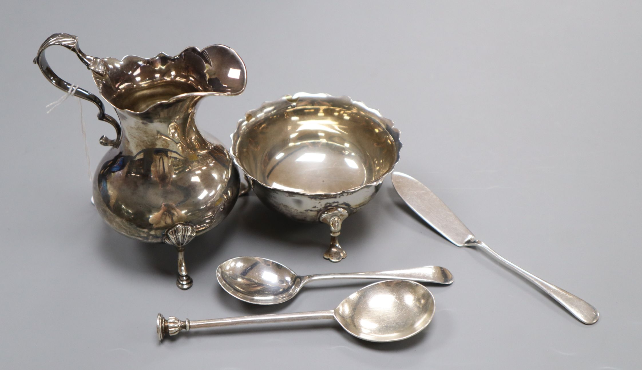 A Victorian silver cream jug, London, 1844, a later silver sugar bowl and three items of silver