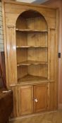 A late 18th century stripped pine standing corner cabinet W.230cm