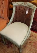 A Regency painted and decorated caned back bergere chair