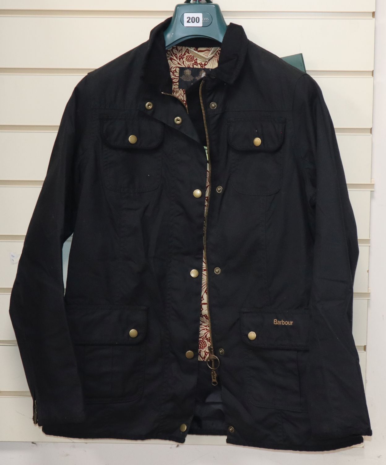 A new ladies Barbour black wax jacket with William Morris print lining, size 14