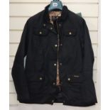 A new ladies Barbour black wax jacket with William Morris print lining, size 14