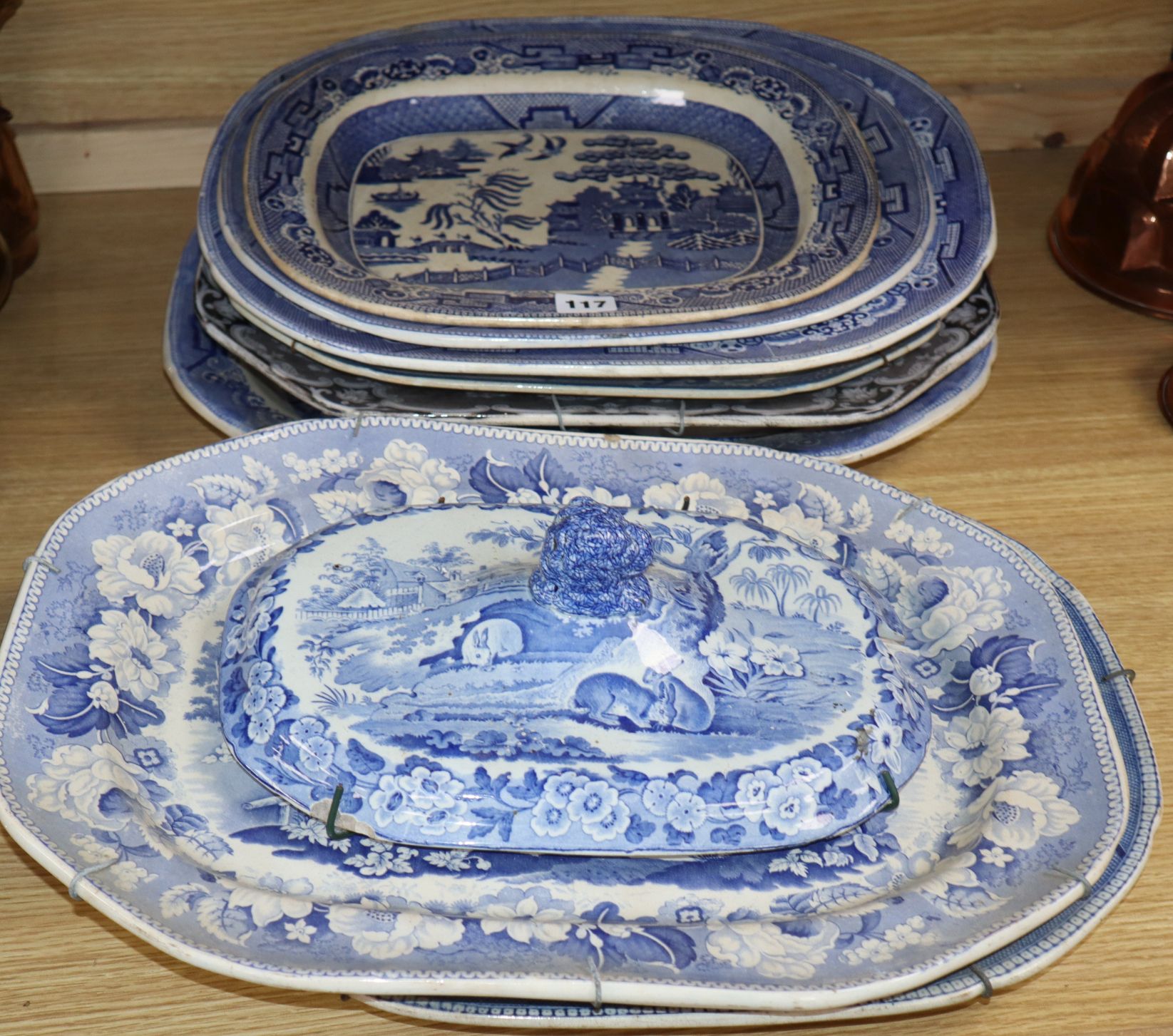 A collection of blue and white meat platters and a cover