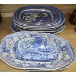 A collection of blue and white meat platters and a cover