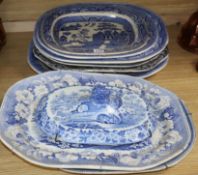 A collection of blue and white meat platters and a cover