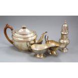 A pair of Edwardian silver sauce boats, a silver sugar caster and a silver teapot, gross 36 oz.