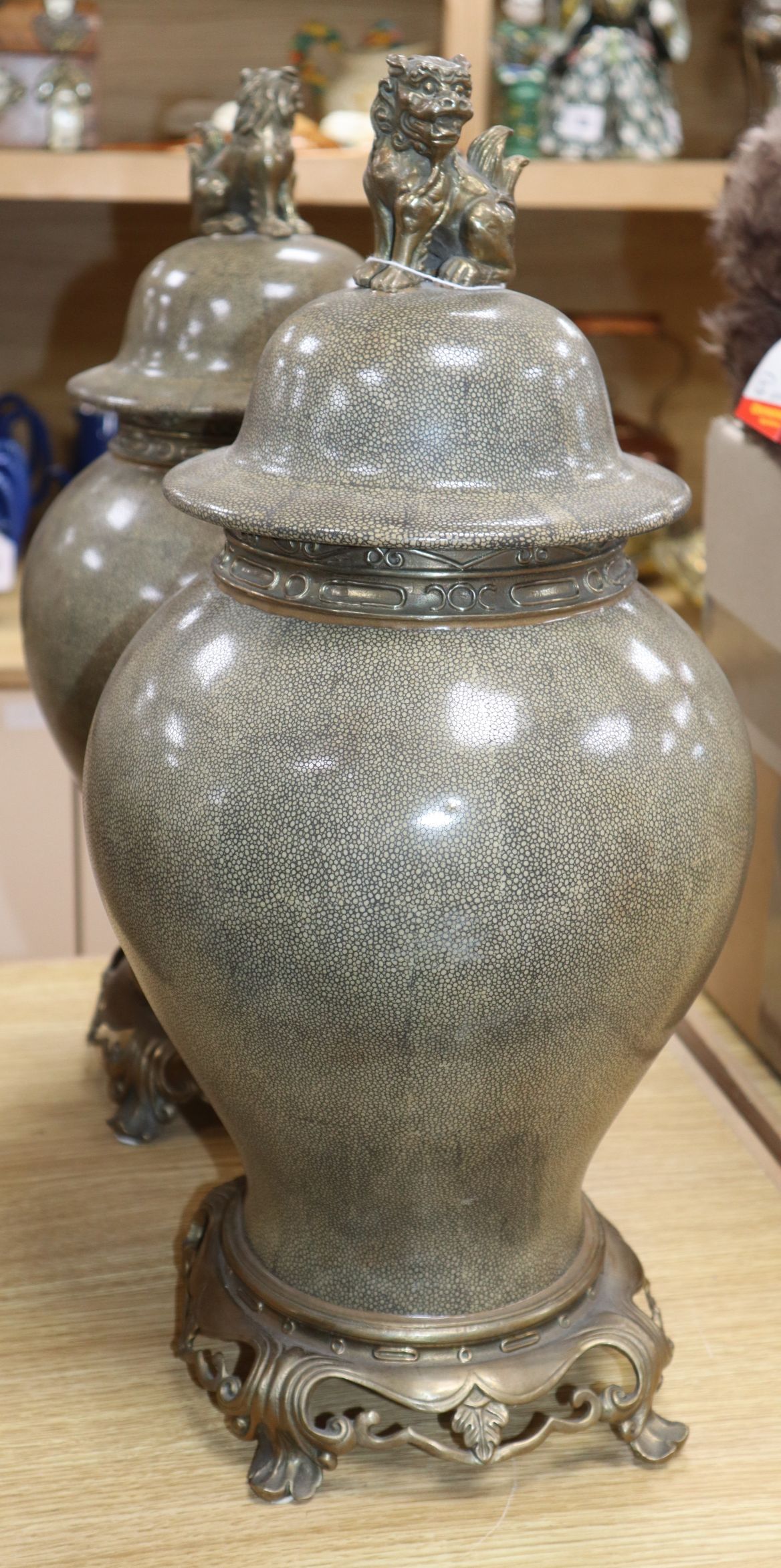 A pair of ceramic faux shagreen lidded vases