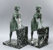 A pair of Art Deco green patinated spelter and marble figure bookends