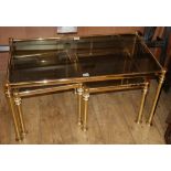 A nest of three modern gilt metal and smoked glass occasional tables W.90cm