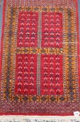 A Bokhara design red ground rug Approx. 120 x 80cm