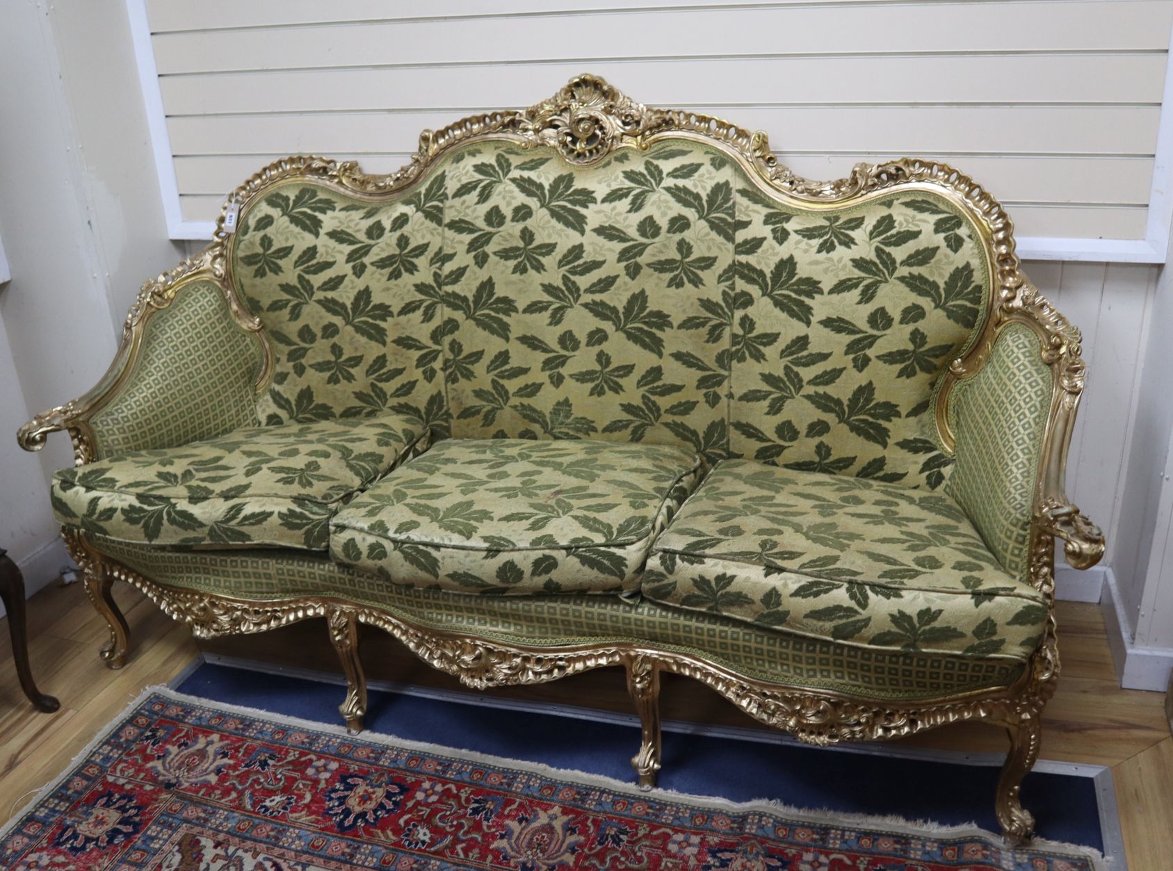 A Louis XVI style giltwood three seater carved settee W.206cm
