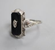 A 10k white metal, black onyx and diamond set shaped rectangular ring, size L.