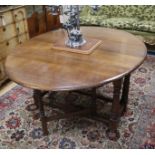 An 18th century style oak gateleg dining table 150cm extended