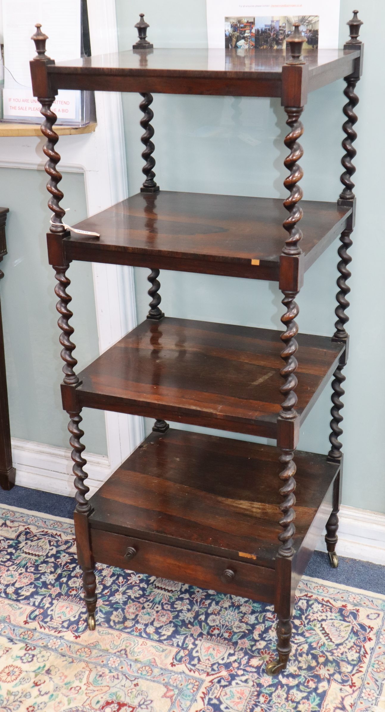 A Victorian rosewood four-tier whatnot with spiral-turned supports and casters W.52cm