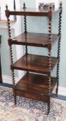 A Victorian rosewood four-tier whatnot with spiral-turned supports and casters W.52cm