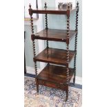 A Victorian rosewood four-tier whatnot with spiral-turned supports and casters W.52cm