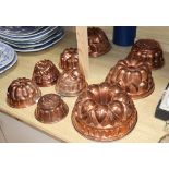 A collection of nine copper jelly moulds