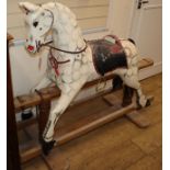 An early 20th century dapple grey wood rocking horse (lacking frame fixings) H.113cm