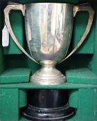 An Art Deco silver trophy cup, by Edward Barnard & Sons Ltd, London, 1932, 22.5oz, in bespoke wooden