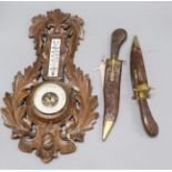 A wood and brass-mounted 'dagger' two-piece carving set and a wall barometer/thermometer in carved