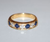 A modern 18ct gold, four stone sapphire and three stone diamond half hoop ring, size M.
