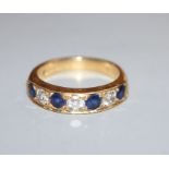 A modern 18ct gold, four stone sapphire and three stone diamond half hoop ring, size M.