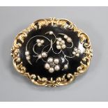 A 19th century yellow metal, black enamel and seed pearl set mourning brooch, in memory of