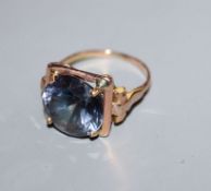 A yellow metal and synthetic colour change corundum set dress ring, size L.