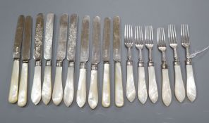 A set of six Edwardian silver dessert knives and forks with mother of pearl handles by Mappin & Webb