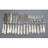 A set of six Edwardian silver dessert knives and forks with mother of pearl handles by Mappin & Webb