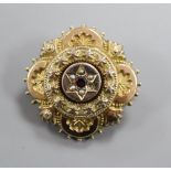 A Victorian yellow metal, gem and seed pearl set brooch, with glazed back, 30mm.