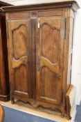 An early 19th century French oak and fruitwood armoire W.134cm