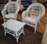 A painted wicker settee, table and a pair of chairs Settee W.136cm