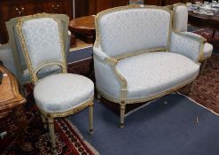 A Louis XVI style five piece salon suite, with carved silvered frames, comprising a sofa, a pair