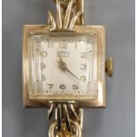 A lady's 9ct gold Trebex manual wind wrist watch, on a 9ct bracelet.