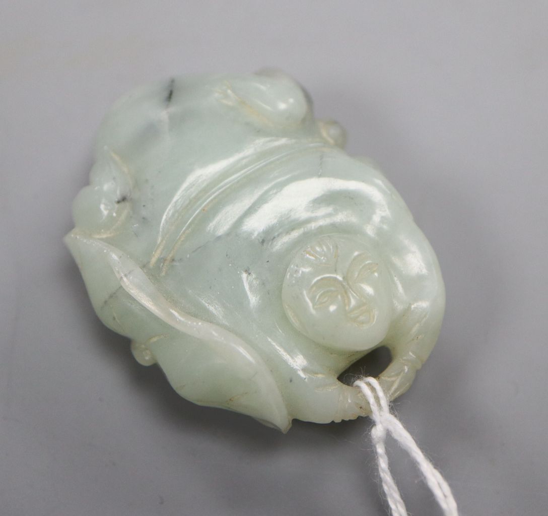 A Chinese pale celadon and grey jade figure of a man and lotus